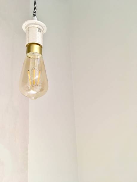 istock Yellow Light Bulb Hanging on The Wall 865439836