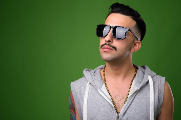 Young Handsome Iranian Man With Mustache Wearing Hooded Shirt Against Green Background Stock Photo - Download Image Now - iStock Young Handsome Iranian Man With Mustache Wearing Hooded Shirt Against Green Background Stock Photo - Download Image Now - iStock