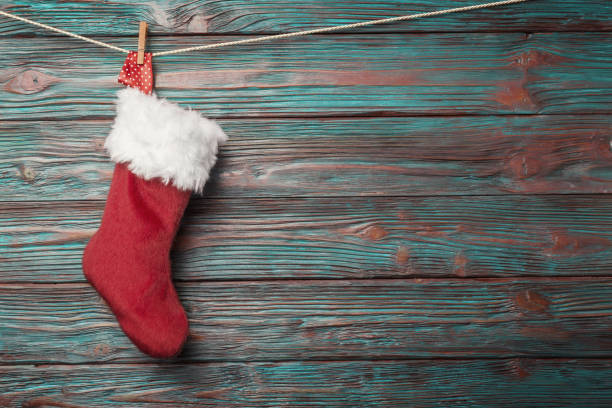 istock Christmas sock over rustic wooden background 865443688