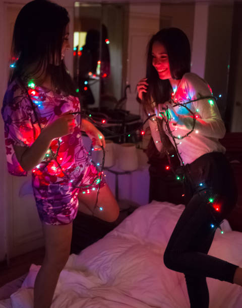 Teens Enjoy Christmas Time Jumping on Bed