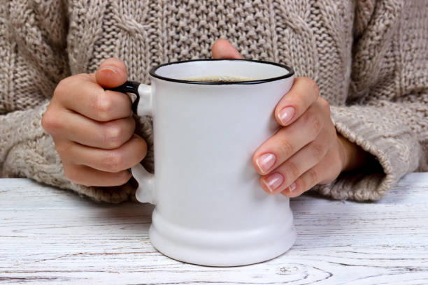 istock Woman's hands holding cup with coffee, top view 865449476