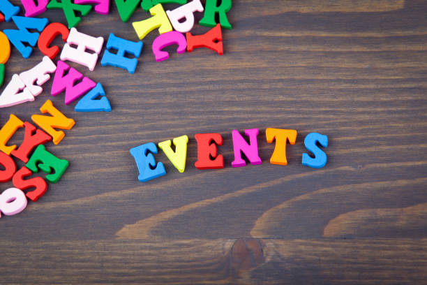istock events. arious colored wooden letters on a dark plate 865452196