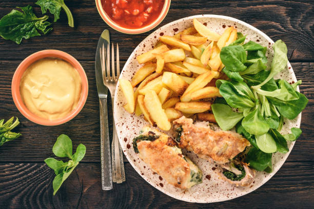 istock Pork roulades with spinach and cheese filling, served with fried potatoes. 865452316