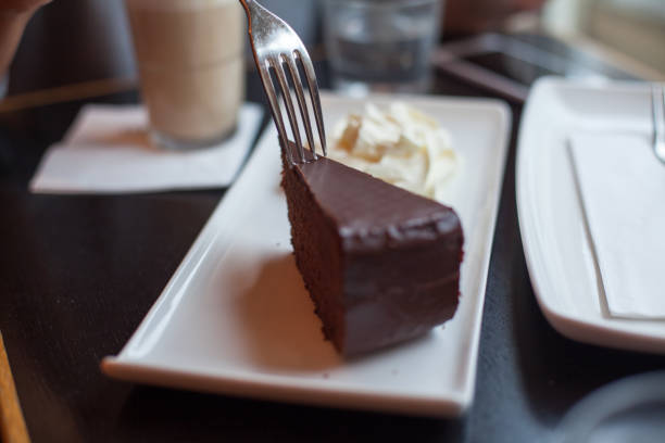 Woman eating Chocolate cake at the cafe