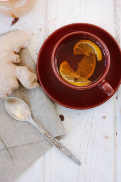 istock Ginger tea with lemon, lime and honey on white. 865459424