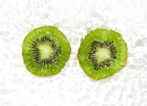 istock juicy kiwi fruit in water on a white background. macro 865459676