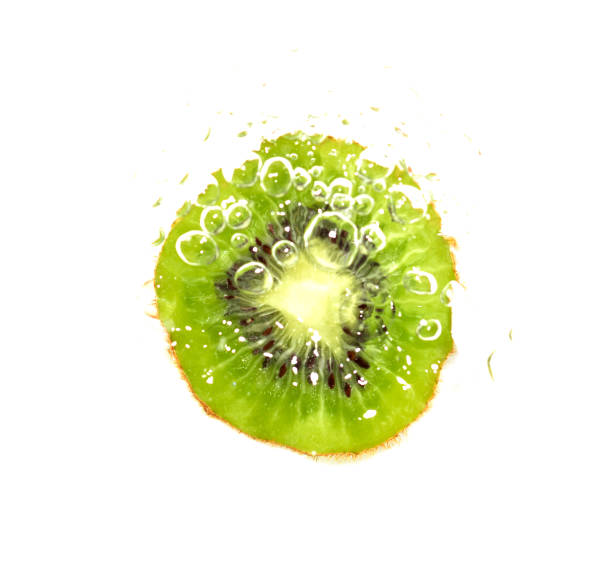 istock juicy kiwi fruit in water on a white background. macro 865460322