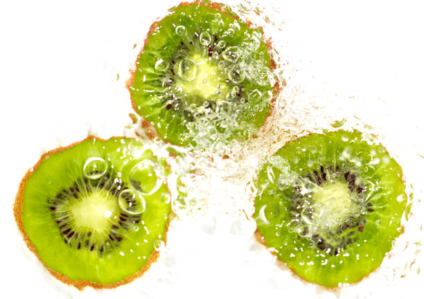 istock juicy kiwi fruit in water on a white background. macro 865460664