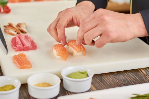 istock Chef hands cooking nigiri sushi. 865460700