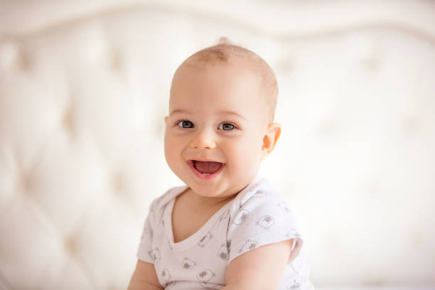 portrait of joyful baby boy childhood, babyhood and people concept - portrait of joyful baby boy. cute baby laughing stock pictures, royalty-free photos & images