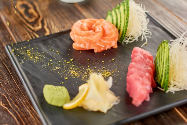istock Raw salmon and tuna served with cucumber. 865463808