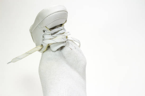 One size doesn't fit all demonstrated by a big foot trying on a baby shoe