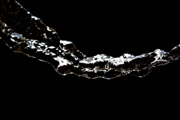 istock stream of water on a black background 865464478