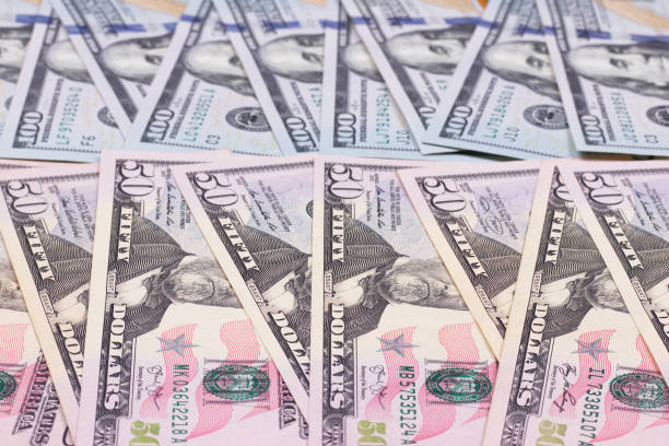 istock 100 and 50 US dollar abstract background. 865464522