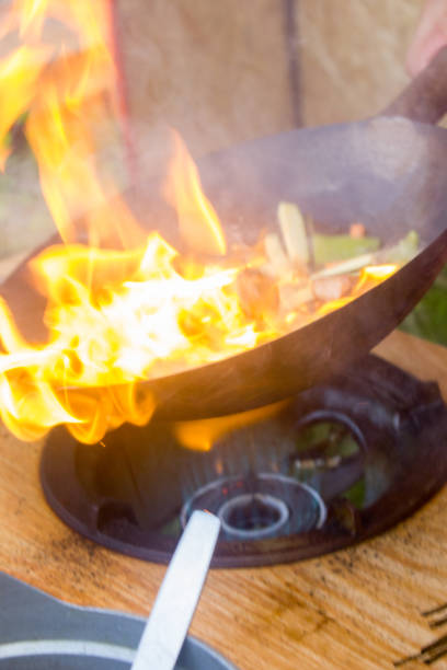 istock Traditional chinese food - wok cooking on open fire. 865467994