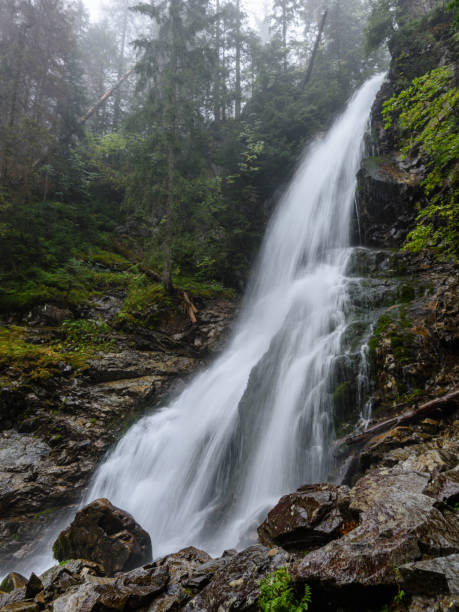 istock large Waterfall from ravine in autumn, long exposure 865471096