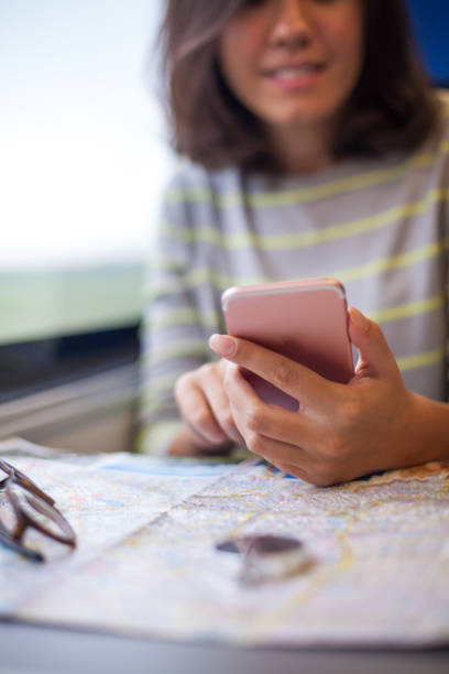 istock Woman in train with smartphone 865471104