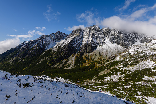 panoramic view of Tatra mountains in Slovakia covered with snow and hiding in mist. high altitude
