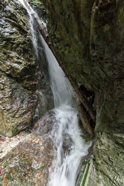 istock large Waterfall from ravine in autumn, long exposure 865477314