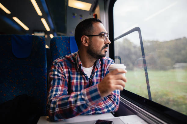 istock Young man traveling in the train 865477390