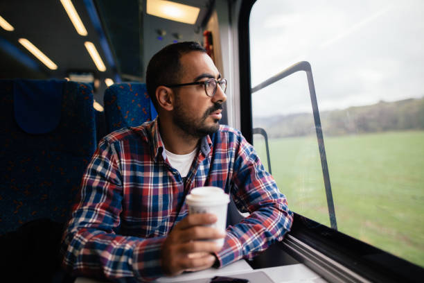 istock Young man traveling in the train 865477410