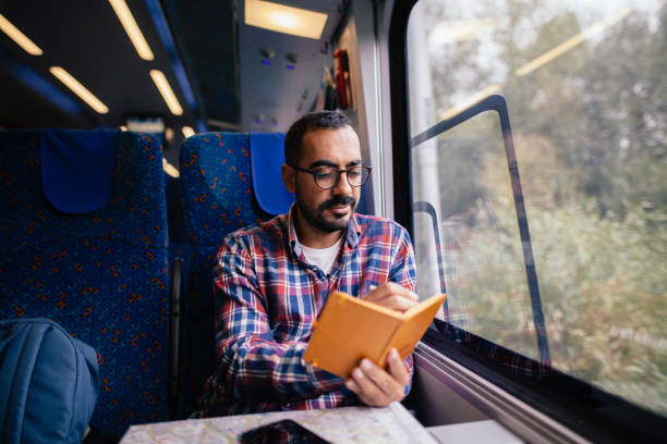 istock Young man traveling in the train 865477644