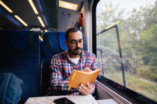 istock Young man traveling in the train 865477676