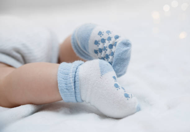 istock Baby feet in socks 865487408