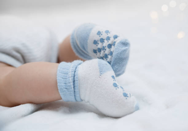 Baby feet in socks stock photo