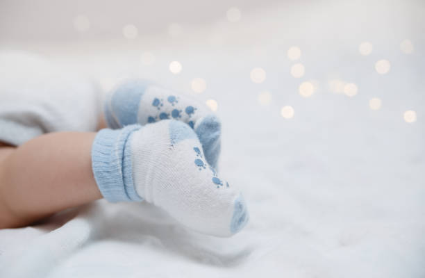 Baby feet in socks stock photo