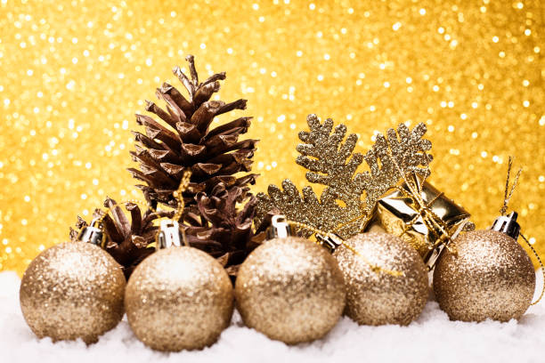istock Christmas composition of Christmas tree toys on a gold background 865487522