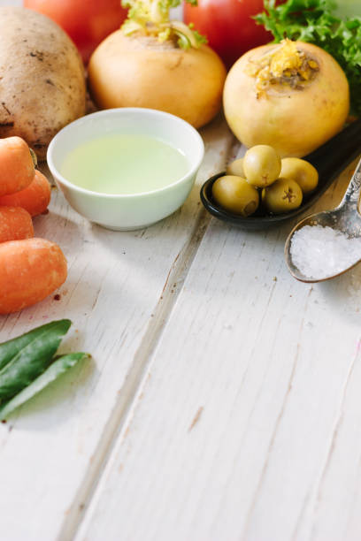 istock Vegetables, olives and spices over white wooden table. 865487918