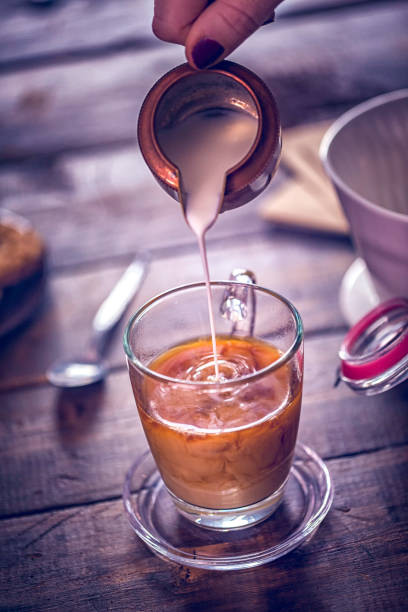 istock Pouring Milk into Cup of Coffee 865493016