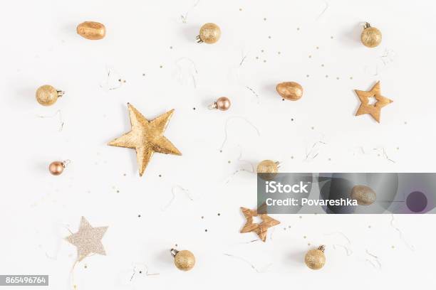 Christmas Golden Decorations On White Background Flat Lay Top View Stock Photo - Download Image Now