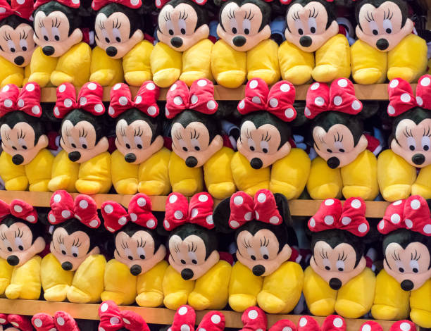 Orlando: Stacked shelf of Minnie Mouse plush toys in a shop.  Florida, USA