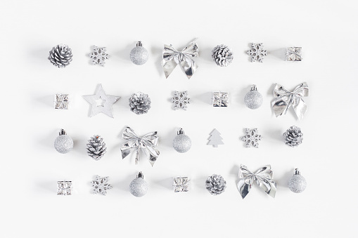 Christmas composition. Christmas silver decorations on white background. Flat lay, top view