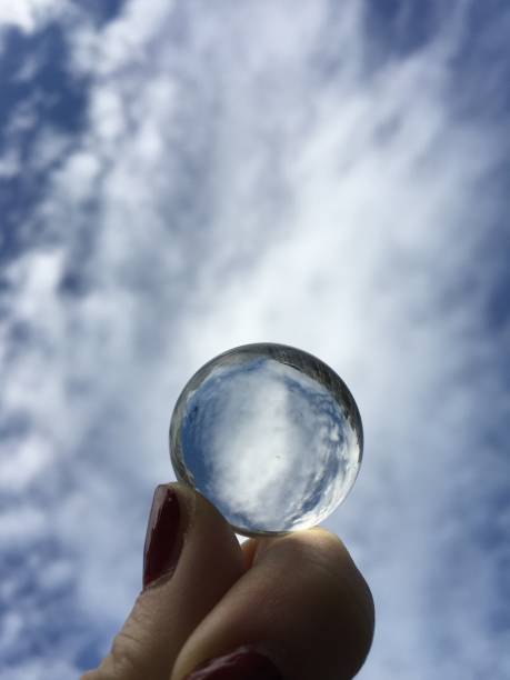 istock Glass sphere reflecting the clouds and sky 865503152