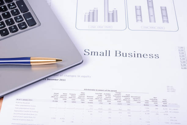 istock Table lying on it with laptop, pen and the financial reports and tables 865512314