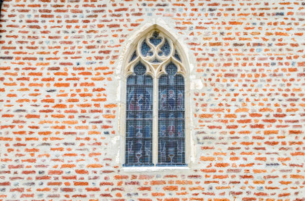 church window in the middle of a brick wall