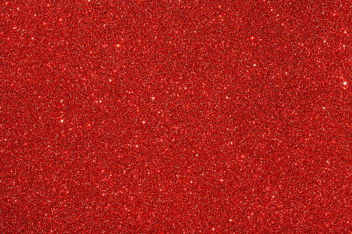 Red (ruby) glitter background. Sparkle texture. Abstract background for New Years or Christmas holiday