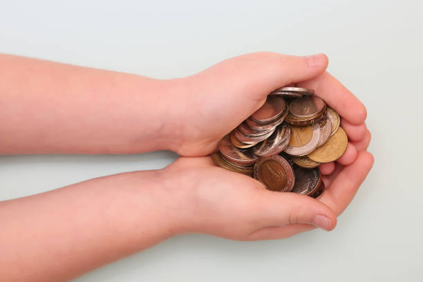 istock Banknotes and coins on the table and in the hands 865516168