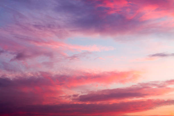 Dynamic blue sky with red and purple clouds during sunset.