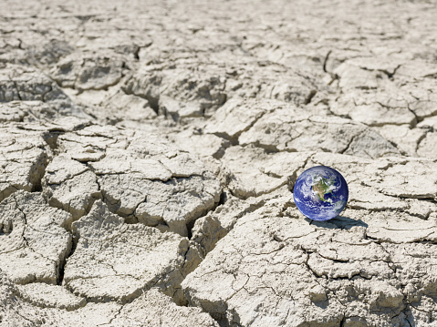 Blue Planet Earth On Cracked Ground