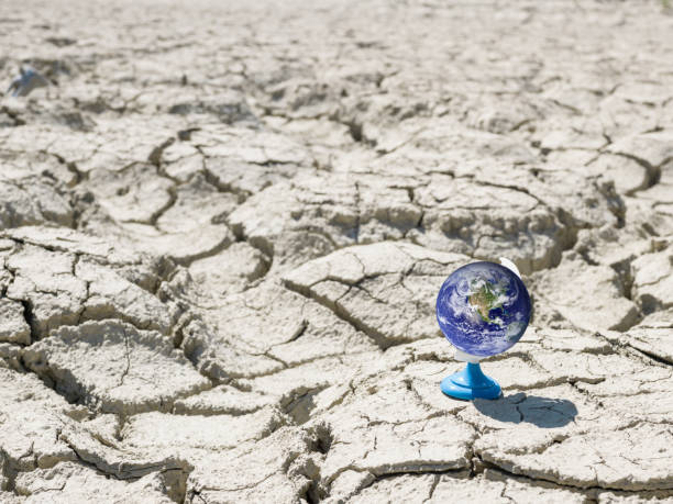 istock Blue Planet Earth On Cracked Ground 865530396