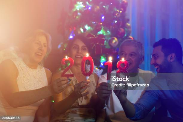 Family On The Living Room Celebrating The New Year 2018 Stock Photo - Download Image Now
