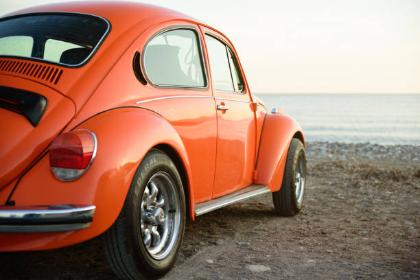 Volkswagen Beetle Izmir, Turkey - October 21, 2017 :Classic orange wolkswagen beetle, photo taken in a sea coast of Izmir city, Turkey. No people around. beetle photos stock pictures, royalty-free photos & images