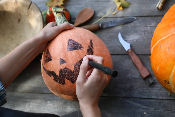 istock carve pumpkins for Halloween 865540620
