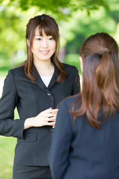 istock asian businesswoman talking in park 865540878