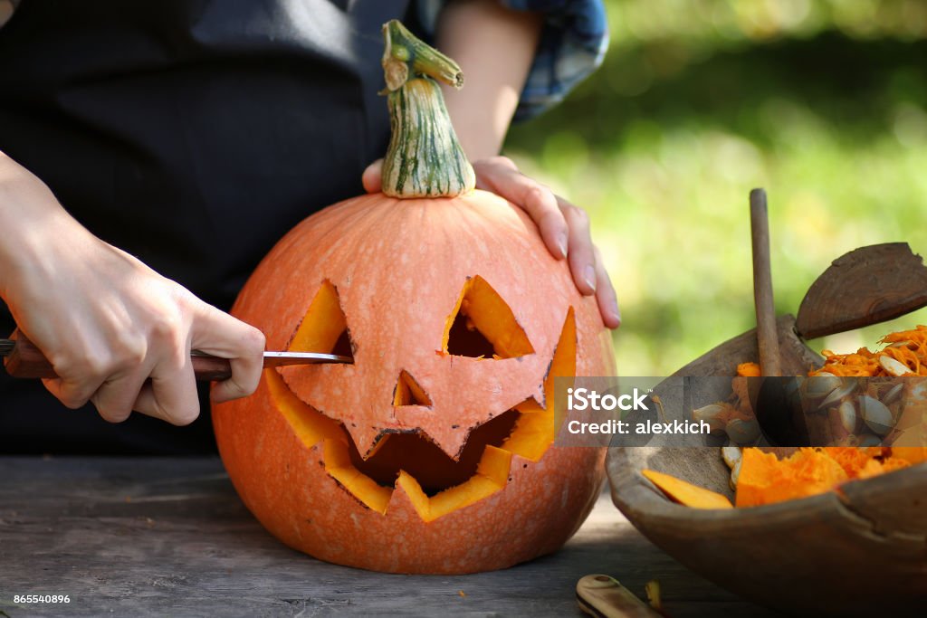 carve pumpkins for Halloween Head carved from pumpkin and monster on holiday Pumpkin Stock Photo