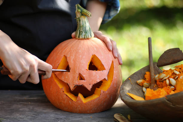 carve pumpkins for Halloween Head carved from pumpkin and monster on holiday pumpkin stock pictures, royalty-free photos & images